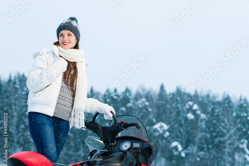 Photo: Woman and snowmobile Woman and snowmobile