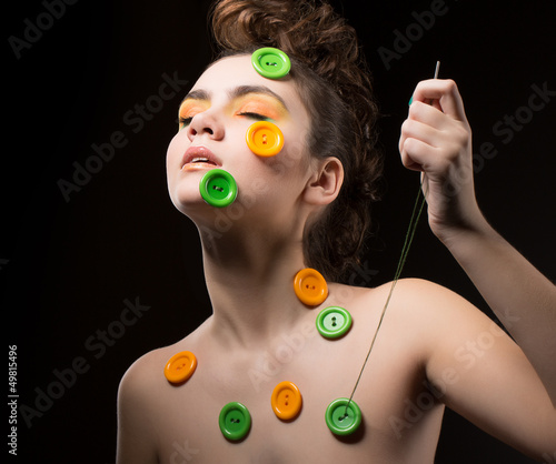 Photo: Tailor. Artistic Woman with Colorful Buttons and Needle. Sewing Tailor. Artistic Woman with Colorful Buttons and Needle. Sewing