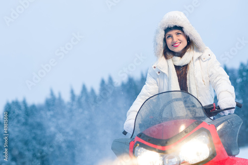 Photo: Woman and snowmobile Woman and snowmobile