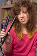 Photo: teenage girl with messy hair and flatiron straightener teenage girl with messy hair and flatiron straightener