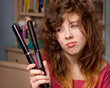 Photo: teenage girl with messy hair and flatiron straightener teenage girl with messy hair and flatiron straightener
