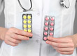 Close-up of female doctor hand holding pills,