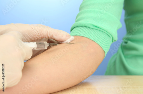 Photo: Doctor holding syringe with a vaccine in the patient hand, Doctor holding syringe with a vaccine in the patient hand,