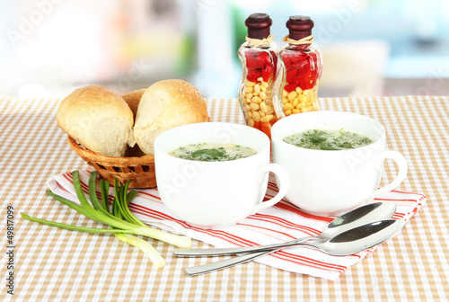Photo: Fragrant soup in cups on table in kitchen Fragrant soup in cups on table in kitchen