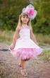 Photo: Beautiful little girl in a pink dress walking Beautiful little girl in a pink dress walking
