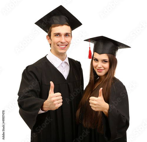Photo: Two happy graduating students isolated on white Two happy graduating students isolated on white
