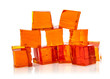 Orange jelly cubes on white background