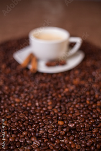 Photo: Coffee cup on dark roasted beans Coffee cup on dark roasted beans