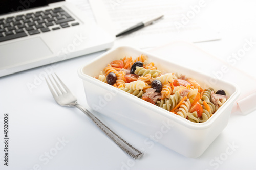 Photo: Eating a pasta salad in the office Eating a pasta salad in the office