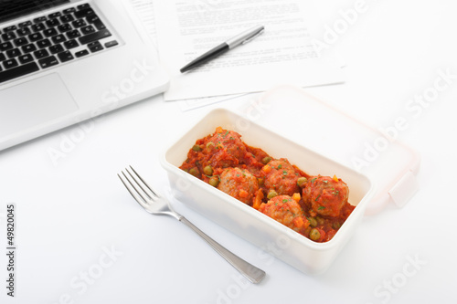 Photo: Eating meatballs with tomato in the office Eating meatballs with tomato in the office