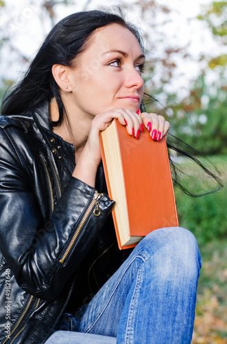 Photo: Thoughtful woman with a book Thoughtful woman with a book