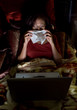 Asian woman having colds while working in the dark