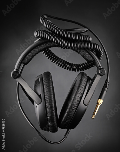 Photo: Modern headphones over dark background Modern headphones over dark background
