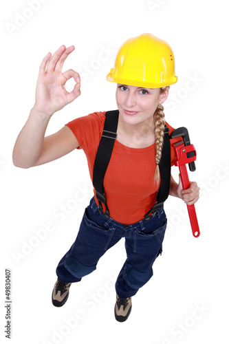Photo: Female plumber giving the OK Female plumber giving the OK