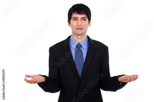 Photo: Businessman weighing up options Businessman weighing up options