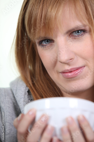 Photo: Woman cradling a breakfast bowl in her hands Woman cradling a breakfast bowl in her hands