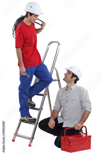 Photo: Team of electricians on white background Team of electricians on white background