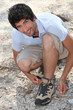 young man lacing his shoes