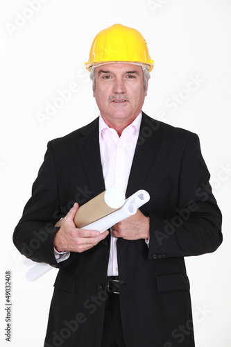 Photo: Senior architect carrying plans Senior architect carrying plans
