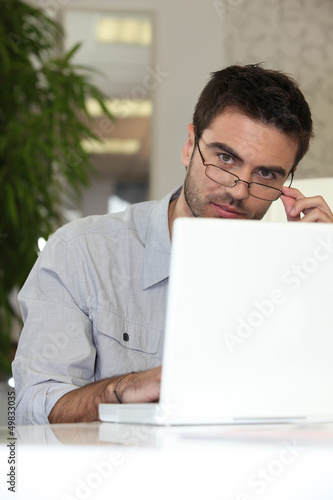 Photo: Man working on laptop Man working on laptop