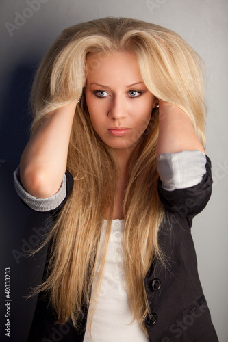 Photo: Serious blonde launched her hands under her hair Serious blonde launched her hands under her hair