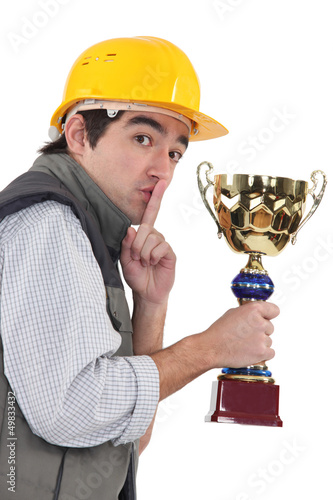Photo: Secretive construction worker with a trophy Secretive construction worker with a trophy