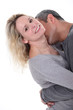 Man kissing wife's neck