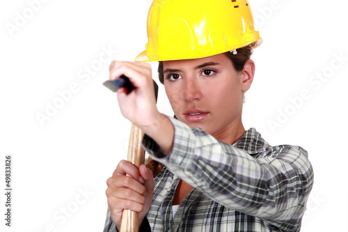 Photo: Young woman using a hammer Young woman using a hammer