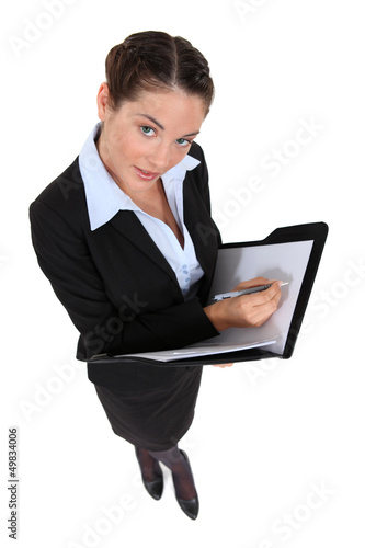 Photo: A businesswoman taking notes. A businesswoman taking notes.