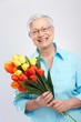 Grandmother with flowers smiling