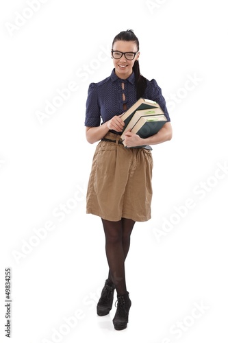 Photo: Young school-marm with books smiling Young school-marm with books smiling