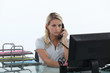 Woman sitting at her desk on the phone