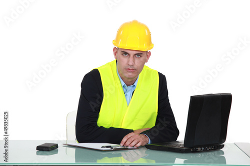 Photo: helmeted foreman with laptop helmeted foreman with laptop