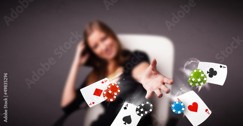 Photo: Young woman playing with poker cards and chips Young woman playing with poker cards and chips