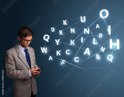 Photo: Young man typing on smartphone with high tech 3d letters comming Young man typing on smartphone with high tech 3d letters comming