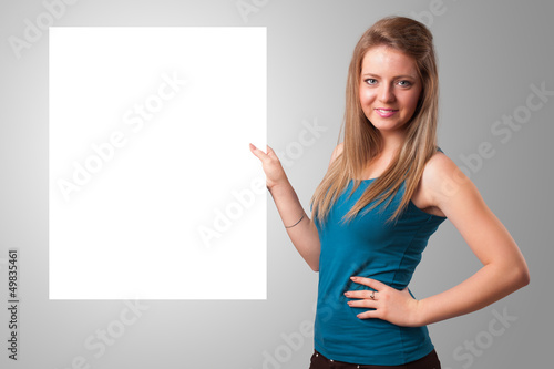 Photo: Young woman presenting white paper copy space Young woman presenting white paper copy space