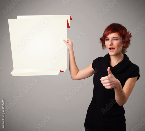 Photo: Young woman holding white origami paper copy space Young woman holding white origami paper copy space