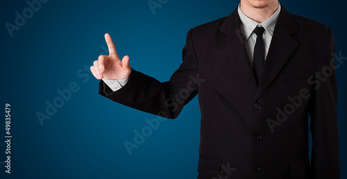 Photo: Businessman pressing imaginary button Businessman pressing imaginary button