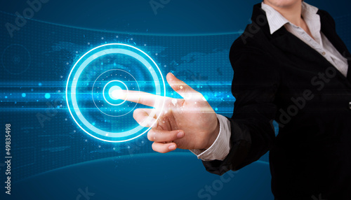 Photo: Woman pressing high tech type of modern buttons Woman pressing high tech type of modern buttons