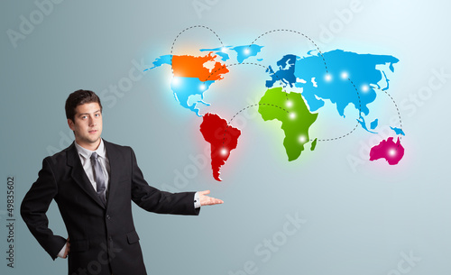 Photo: young man presenting colorful world map young man presenting colorful world map