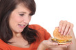 brunette looking at burger