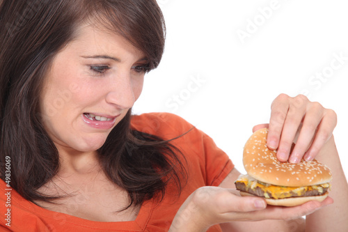 Photo: brunette looking at burger brunette looking at burger
