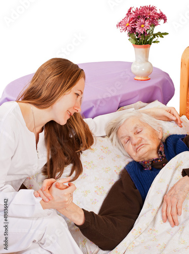 Photo: Young doctor holds the elderly woman hands Young doctor holds the elderly woman hands