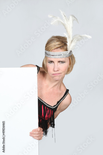 Photo: Woman in party dress holding marketing board Woman in party dress holding marketing board