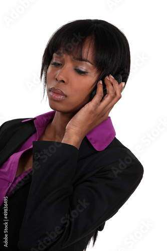 Photo: A sad businesswoman over the phone. A sad businesswoman over the phone.