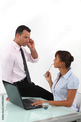 Photo: Flirtatious business duo Flirtatious business duo