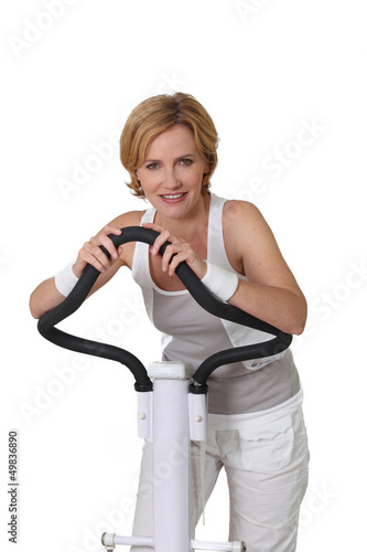 Photo: Woman on exercise machine Woman on exercise machine