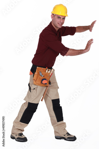 Photo: Construction worker pushing empty copyspace Construction worker pushing empty copyspace