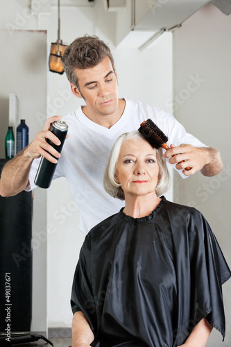 Photo: Woman With Hairdresser Styling Hair At Salon Woman With Hairdresser Styling Hair At Salon