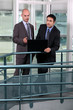 Businessmen, using laptop on hall